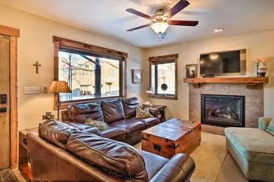 a living room with a couch and a fireplace at Central Fraser Condo 8 Mi to Winter Park Ski! in Fraser