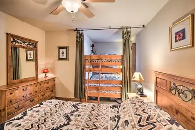 a bedroom with a bed and a dresser and a mirror at Central Fraser Condo 8 Mi to Winter Park Ski! in Fraser