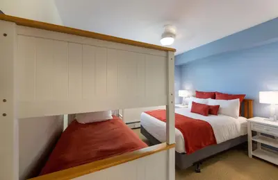 a bedroom with a bunk bed with red pillows at Winter Park FF Premium Rated Condo 4340 in Winter Park