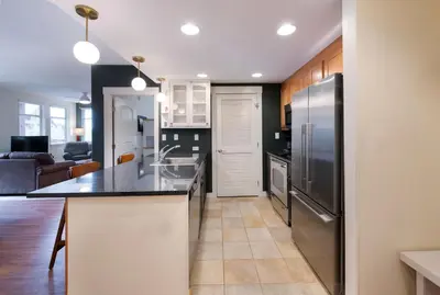 a kitchen with stainless steel appliances and a living room at Winter Park FF Premium Rated Condo 4340 in Winter Park