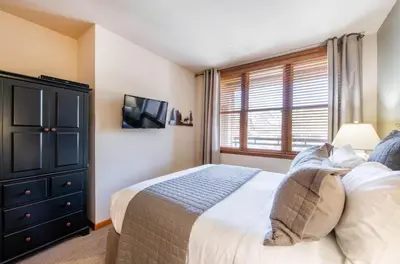a bedroom with a bed and a window at Zephyr Mountain Lodge Select-Rated 1602 in Winter Park