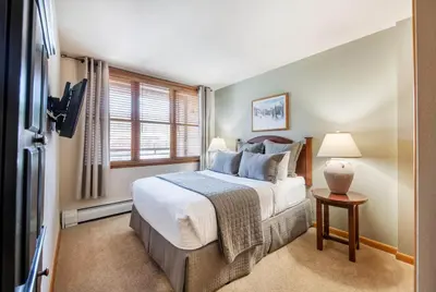 a bedroom with a bed and a window at Zephyr Mountain Lodge Select-Rated 1602 in Winter Park