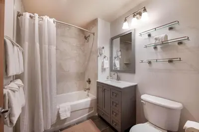 a bathroom with a toilet and a sink and a shower at Zephyr Mountain Lodge Select-Rated 1602 in Winter Park