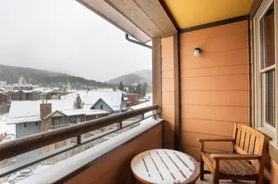 a balcony with a view of a snow covered mountain at Zephyr Mountain Lodge Select-Rated 1602 in Winter Park