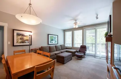 a living room with a couch and a table at Excellent townhome style condo - Close to the Gondola - Fraser Crossing Founder Pointe condo in Winter Park