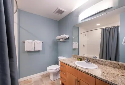 a bathroom with a sink and a toilet and a mirror at Excellent townhome style condo - Close to the Gondola - Fraser Crossing Founder Pointe condo in Winter Park