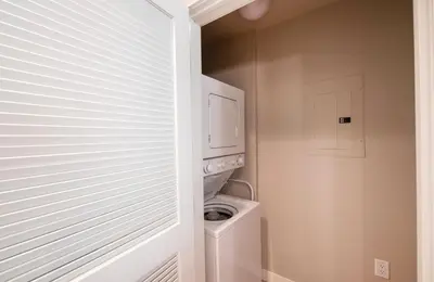 a white laundry room with a washer and dryer at Excellent townhome style condo - Close to the Gondola - Fraser Crossing Founder Pointe condo in Winter Park