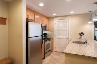 a kitchen with a stainless steel refrigerator and a sink at Simple and Comfortable Fraser Crossing Founders Pointe Condo Facing Ski Resort condo in Winter Park