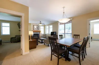 a dining room and living room with a table and chairs at Simple and Comfortable Fraser Crossing Founders Pointe Condo Facing Ski Resort condo in Winter Park