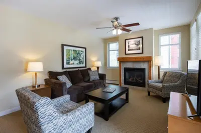 a living room with a couch and a fireplace at Simple and Comfortable Fraser Crossing Founders Pointe Condo Facing Ski Resort condo in Winter Park