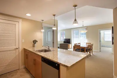a kitchen with a sink and a dining room at Simple and Comfortable Fraser Crossing Founders Pointe Condo Facing Ski Resort condo in Winter Park
