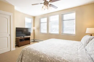a bedroom with a bed and a flat screen tv at Simple and Comfortable Fraser Crossing Founders Pointe Condo Facing Ski Resort condo in Winter Park
