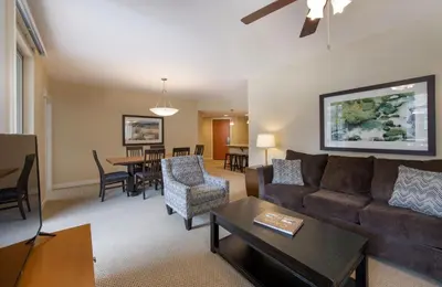 a living room with a couch and a table at Simple and Comfortable Fraser Crossing Founders Pointe Condo Facing Ski Resort condo in Winter Park