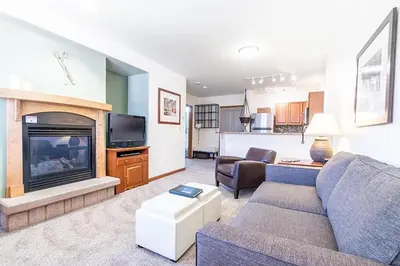 a living room with a couch and a fireplace at Perfectly Cozy 3rd floor Zephyr Mountain Lodge Condo with remodeled bath condo in Winter Park
