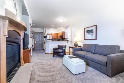 a living room with a couch and a tv at Perfectly Cozy 3rd floor Zephyr Mountain Lodge Condo with remodeled bath condo in Winter Park
