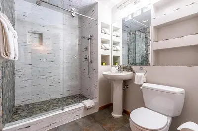a bathroom with a shower and a toilet and a sink at Perfectly Cozy 3rd floor Zephyr Mountain Lodge Condo with remodeled bath condo in Winter Park