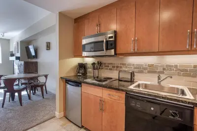 a kitchen with a sink and a microwave at Beautiful Ski-In Ski-Out Top Floor Studio Condo at Fraser Crossing Founders Pointe condo in Winter Park