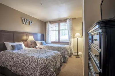 a hotel room with two beds and a window at Ski Slope View Remodeled Zephyr Mountain Lodge Condo condo in Winter Park