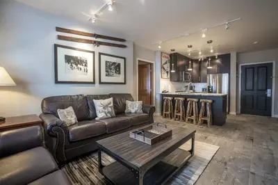 a living room with a couch and a table at Ski Slope View Remodeled Zephyr Mountain Lodge Condo condo in Winter Park