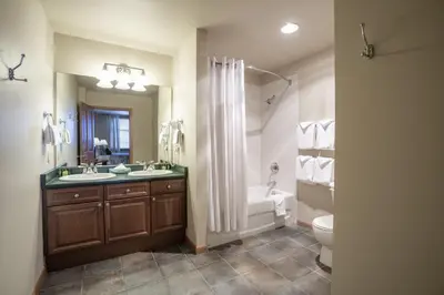 a bathroom with a sink and a tub and a toilet at Ski Slope View Remodeled Zephyr Mountain Lodge Condo condo in Winter Park