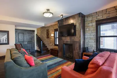 a living room with two couches and a fireplace at Spacious Village View Townhouse with Fireplace at Parry Peak Lofts townhouse in Winter Park