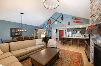 a living room with a couch and a dining room at Spacious Fraser Crossing Founders Pointe Condo with Balcony and Village Views condo in Winter Park