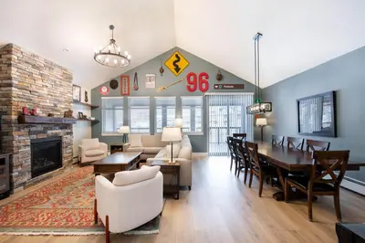 a living room with a fireplace and a dining room at Spacious Fraser Crossing Founders Pointe Condo with Balcony and Village Views condo in Winter Park
