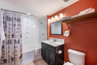 a bathroom with a sink and a toilet and a shower at Spacious Fraser Crossing Founders Pointe Condo with Balcony and Village Views condo in Winter Park
