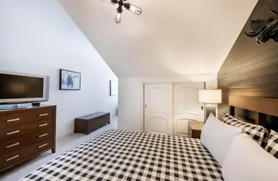 a bedroom with a bed and a tv on a dresser at Spacious Fraser Crossing Founders Pointe Condo with Balcony and Village Views condo in Winter Park