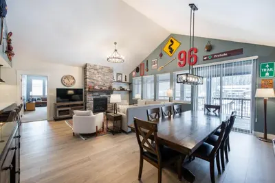 a dining room and living room with a table and chairs at Spacious Fraser Crossing Founders Pointe Condo with Balcony and Village Views condo in Winter Park