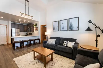a living room with a couch and a table at Zephyr Mountain Lodge Premium-Rated 1705 in Winter Park