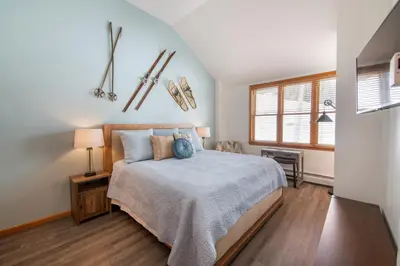 a bedroom with a bed and a window at Zephyr Mountain Lodge Premium-Rated 1705 in Winter Park