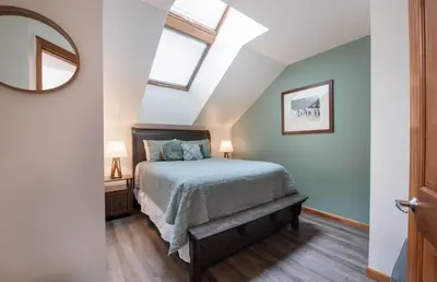 a bedroom with a bed and a mirror at Zephyr Mountain Lodge Premium-Rated 1705 in Winter Park