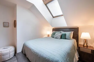 a bedroom with a bed and a skylight at Zephyr Mountain Lodge Premium-Rated 1705 in Winter Park