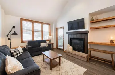 a living room with a couch and a fireplace at Zephyr Mountain Lodge Premium-Rated 1705 in Winter Park
