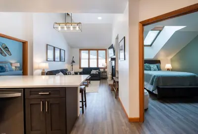 a kitchen and living room with a bed and a bedroom at Zephyr Mountain Lodge Premium-Rated 1705 in Winter Park
