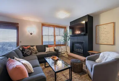 a living room with a couch and a fireplace at Zephyr Mountain Lodge - Premium Rated Condo 1217 in Winter Park