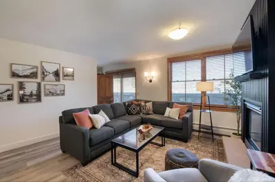 a living room with a couch and a table at Zephyr Mountain Lodge - Premium Rated Condo 1217 in Winter Park