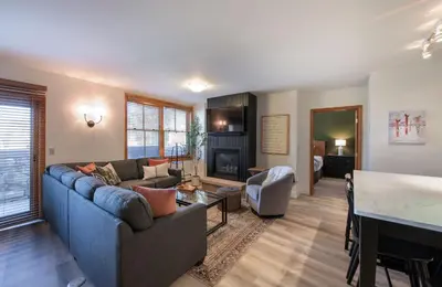 a living room with a couch and a table at Zephyr Mountain Lodge - Premium Rated Condo 1217 in Winter Park