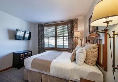 a bedroom with a large bed and a window at Zephyr Mountain Lodge - Premium Rated Condo 1217 in Winter Park