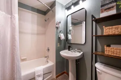 a bathroom with a sink and a tub and a toilet at Zephyr Mountain Lodge - Premium Rated Condo 1217 in Winter Park