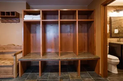a bathroom with a toilet and wooden cabinets at Premium Ski-Slope View Two Bedroom Zephyr Mountain Lodge Condo condo in Winter Park