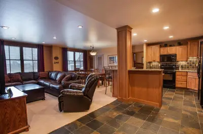 a living room with a couch and a kitchen at Premium Ski-Slope View Two Bedroom Zephyr Mountain Lodge Condo condo in Winter Park