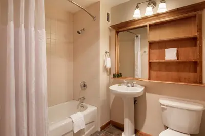 a bathroom with a sink and a toilet and a bath tub at Roomy Zephyr Mountain Lodge Condo with Perfect Slope View from Balcony condo in Winter Park