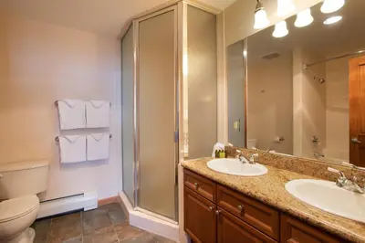 a bathroom with a sink and a shower and a toilet at Roomy Zephyr Mountain Lodge Condo with Perfect Slope View from Balcony condo in Winter Park