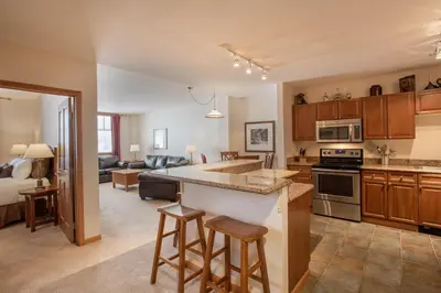 an open kitchen and living room with a couch at Roomy Zephyr Mountain Lodge Condo with Perfect Slope View from Balcony condo in Winter Park