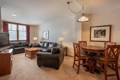 a living room with a couch and a table at Roomy Zephyr Mountain Lodge Condo with Perfect Slope View from Balcony condo in Winter Park