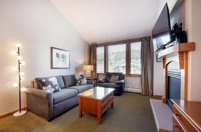 a living room with a couch and a tv at Comfortable Mountain Adventure Condo at Zephyr Mountain Lodge with Village View condo in Winter Park