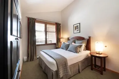 a bedroom with a large bed and a window at Comfortable Mountain Adventure Condo at Zephyr Mountain Lodge with Village View condo in Winter Park