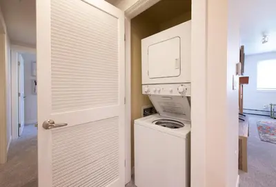 a white laundry room with a washer and dryer at Comfortable Fraser Crossing Founders Pointe Condo with Easy Access to the Gondola condo in Winter Park